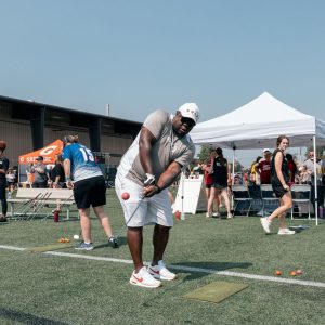 man hits golf ball at outdoor sporting event