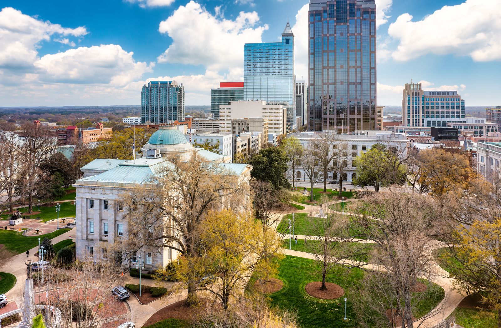 Downtown Raleigh skyline behind the North Carolina State Capitol in fall